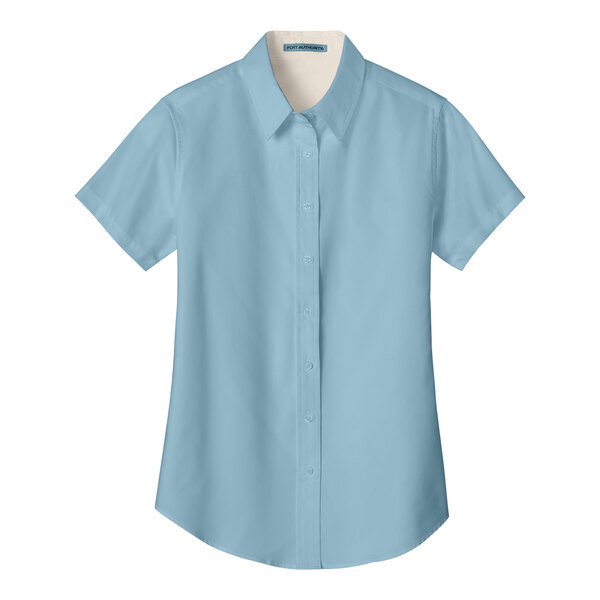 A light blue Port Authority short sleeve dress shirt for women with a tag on it.
