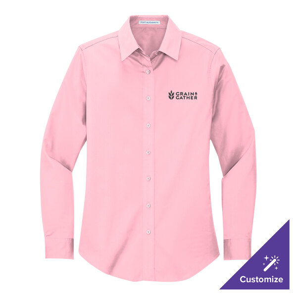 A close-up of a Port Authority light pink long sleeve dress shirt with a company logo.