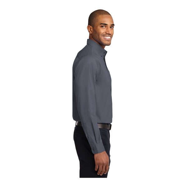 A man wearing a Port Authority steel gray and light stone dress shirt.