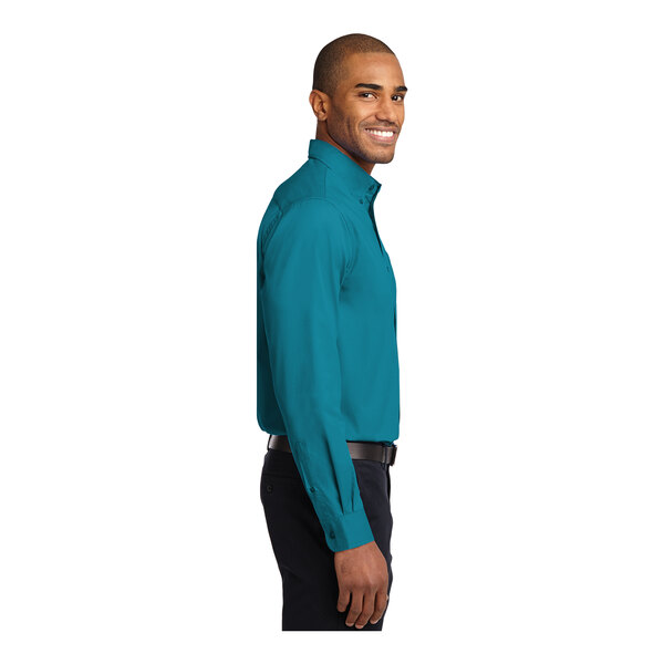 A person wearing a teal green Port Authority long sleeve dress shirt.