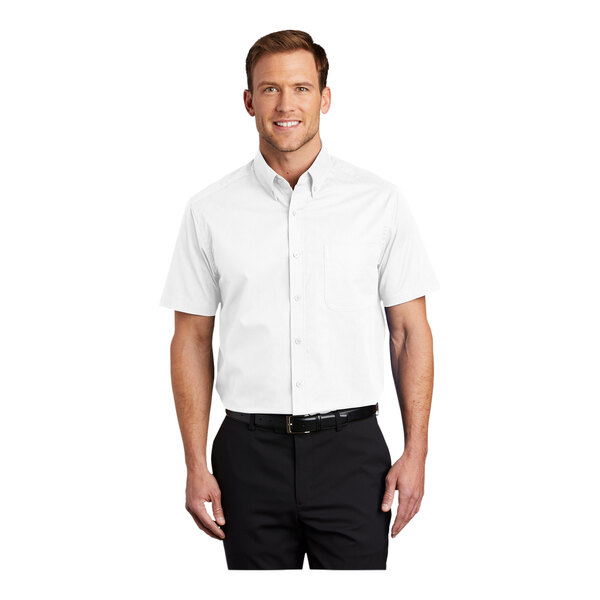 A man wearing a white Port Authority dress shirt with a light stone pattern.