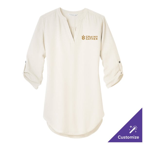 An ivory Port Authority chiffon tunic blouse with gold embroidery on it.