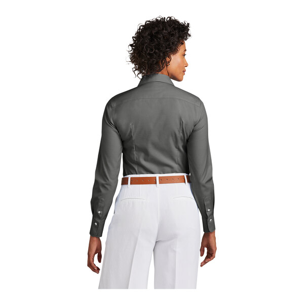 A woman wearing a Brooks Brothers deep black pinpoint stretch dress shirt.