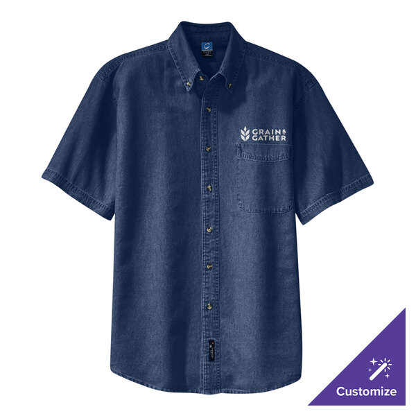 An ink blue Port & Company short sleeve denim button-down shirt with the University of Texas logo on the table.