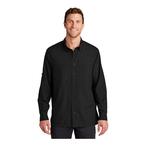A man wearing a deep black Port Authority long sleeve shirt.