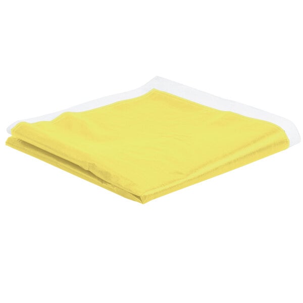 A yellow folded vinyl table cover on a white surface.