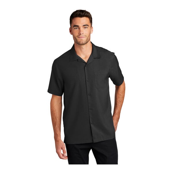 A man wearing a black Port Authority short sleeve staff shirt.