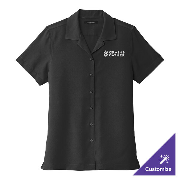 A medium black Port Authority women's short sleeve staff shirt with white text on the front.