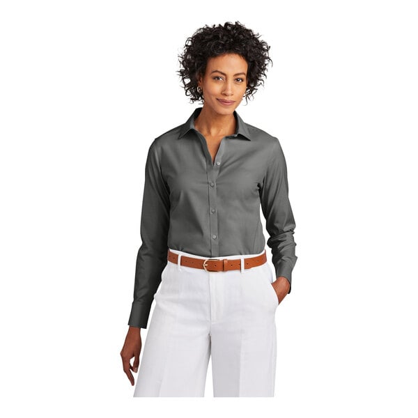 A woman wearing a black Brooks Brothers long sleeve dress shirt.