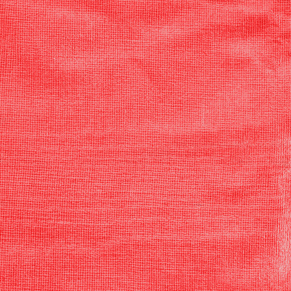 A close up of a red fabric with a white edge.