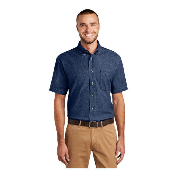 A man wearing an ink blue long sleeve denim button-down shirt.