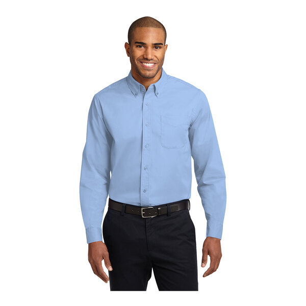 A man wearing a light blue Port Authority long sleeve dress shirt.