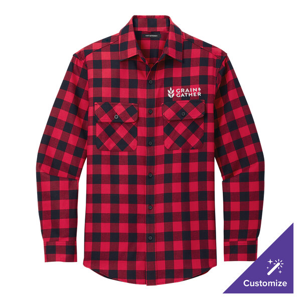 A red and black plaid Port Authority flannel shirt on a table.