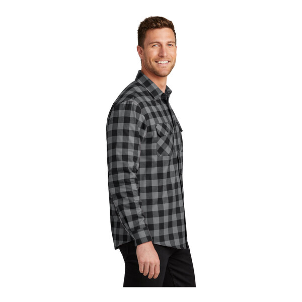 A man wearing a gray and black Port Authority buffalo check flannel shirt.
