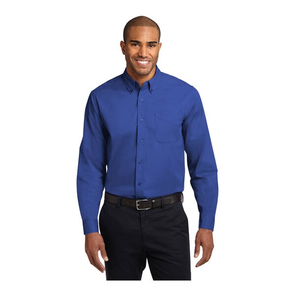 A man wearing a Port Authority long sleeve royal blue dress shirt.