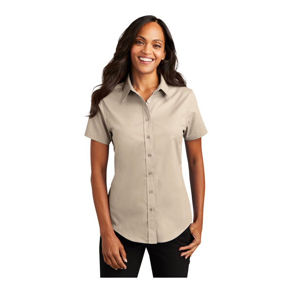 A woman wearing a white Port Authority short sleeve dress shirt.