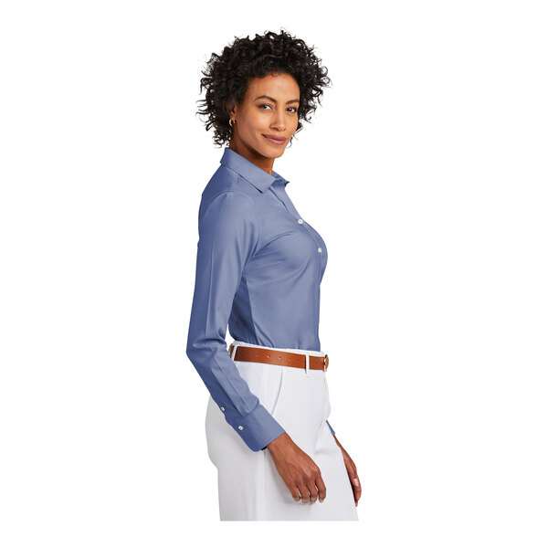 A woman wearing a cobalt blue Brooks Brothers dress shirt.