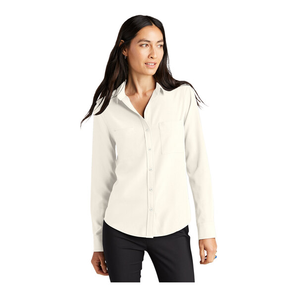 A woman in a Mercer+Mettle ivory chiffon long sleeve camp blouse with a stretch crepe front.