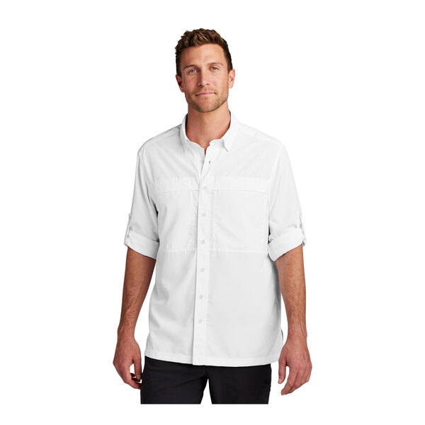 A man wearing a white Port Authority long sleeve shirt.