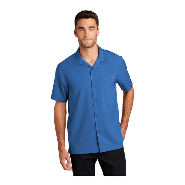 A man wearing a Port Authority True Blue short sleeve staff shirt.