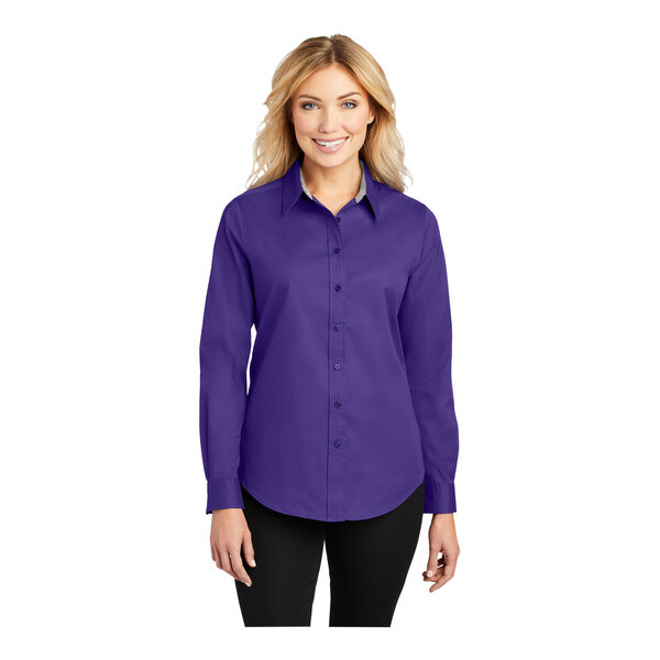 A woman wearing a purple Port Authority long sleeve dress shirt.