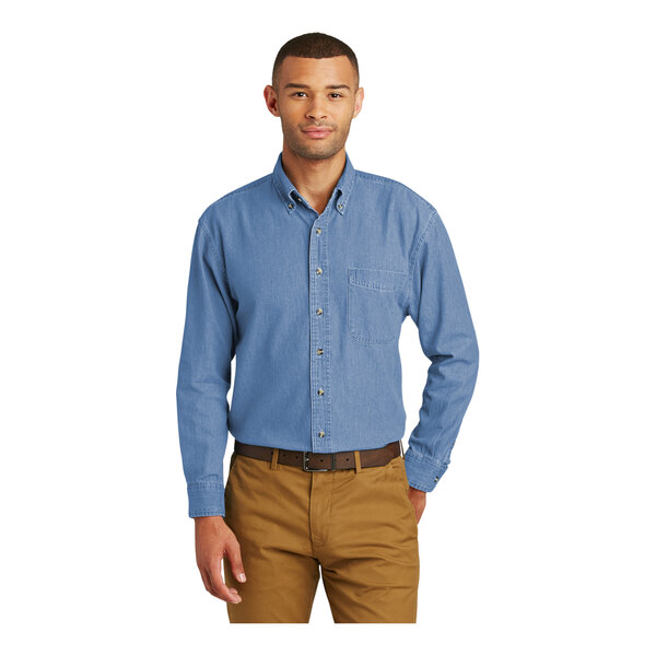 A man wearing a faded blue Port & Company short sleeve denim button-down shirt.
