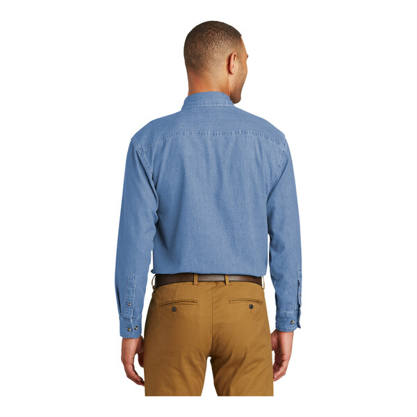 A man wearing a Port & Company faded blue short sleeve denim button-down shirt.