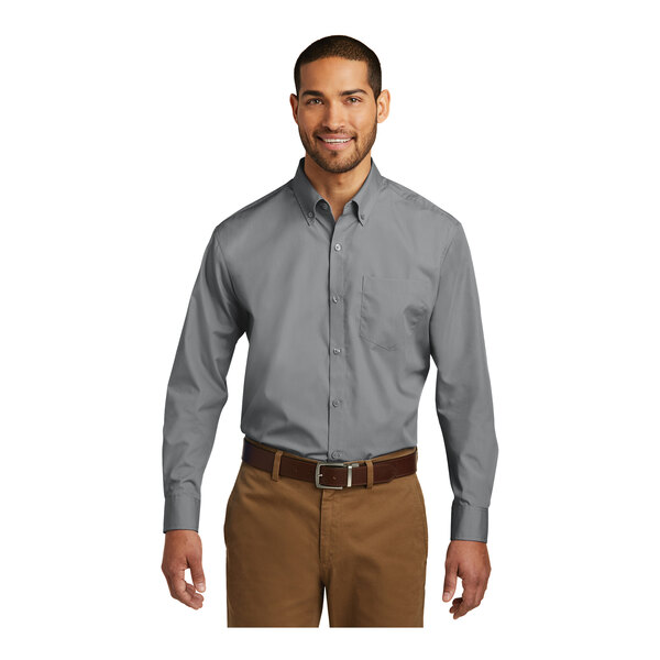 A man wearing a Port Authority gray long sleeve dress shirt.