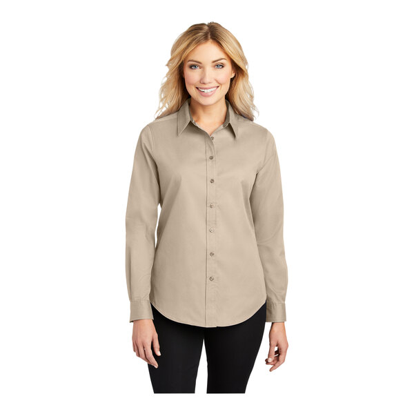 A woman wearing a Port Authority stone long-sleeve dress shirt.