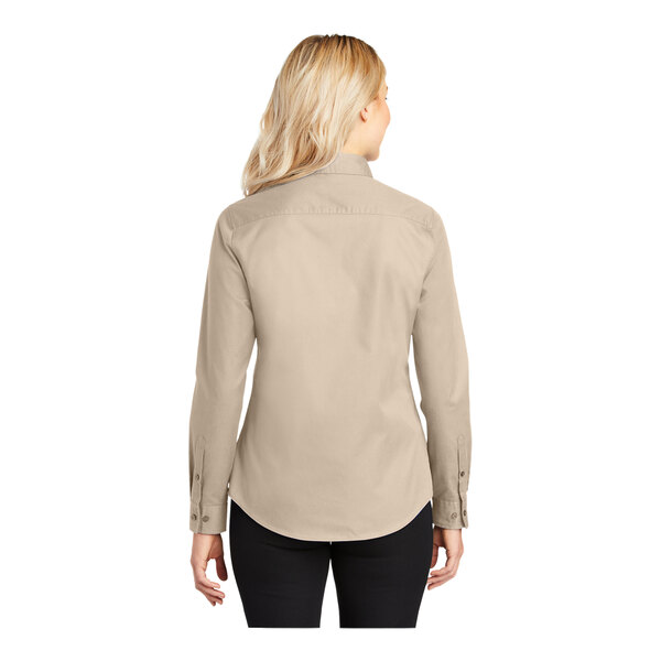 A woman wearing a Port Authority stone long sleeve dress shirt.