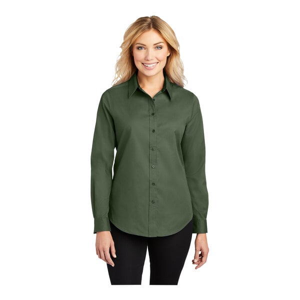 A woman wearing a Port Authority clover green long sleeve dress shirt.