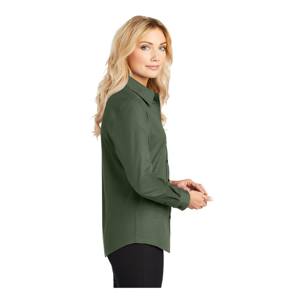A woman with long blonde hair wearing a Port Authority clover green long sleeve button down dress shirt.