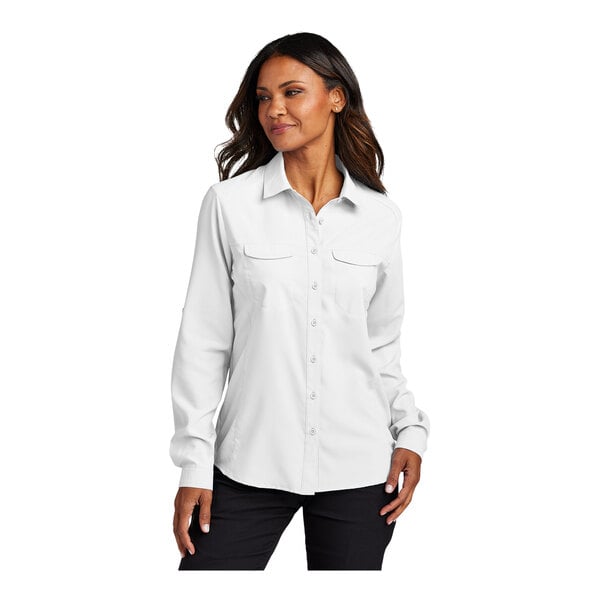 A woman wearing a white Port Authority short sleeve shirt.