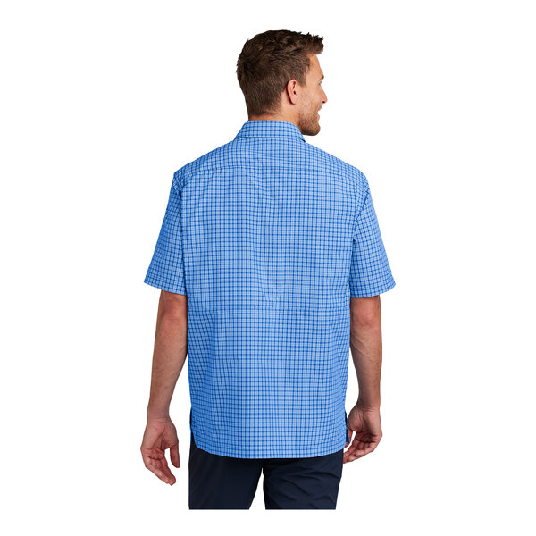 A man wearing a Port Authority blue and white mini plaid shirt.