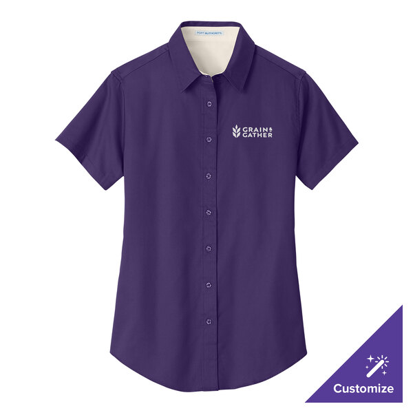 A purple Port Authority women's dress shirt with a white logo.