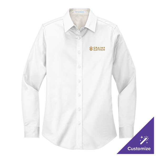 A close-up of a Port Authority white long sleeve dress shirt with gold embroidery.