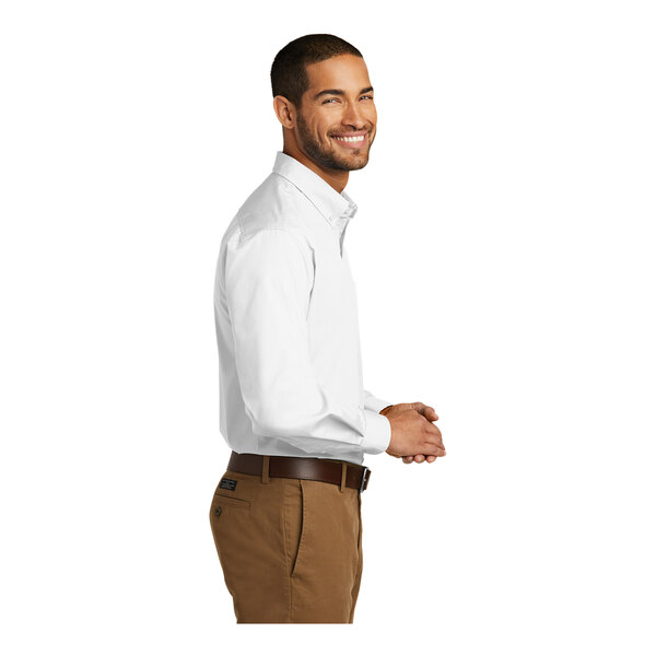 A man wearing a white Port Authority long sleeve dress shirt.