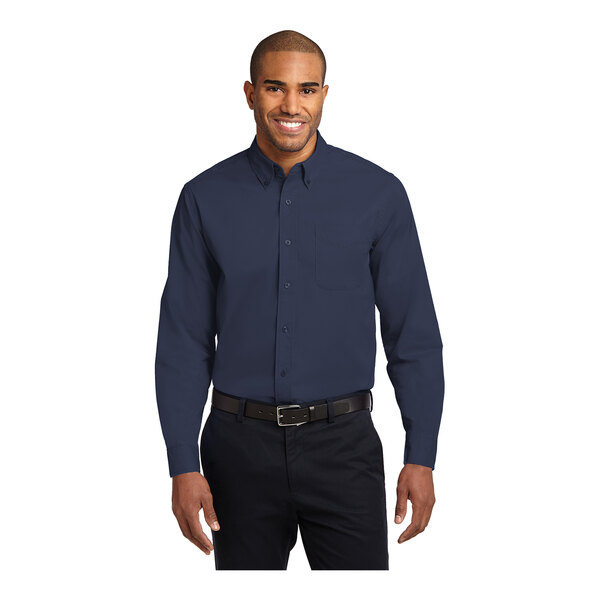 A man wearing a Port Authority navy and light stone long sleeve poplin shirt.