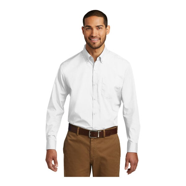 A man wearing a white Port Authority long sleeve poplin dress shirt.