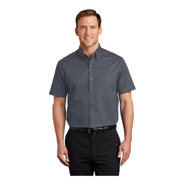 A man wearing a Port Authority steel gray and light stone short sleeve dress shirt.