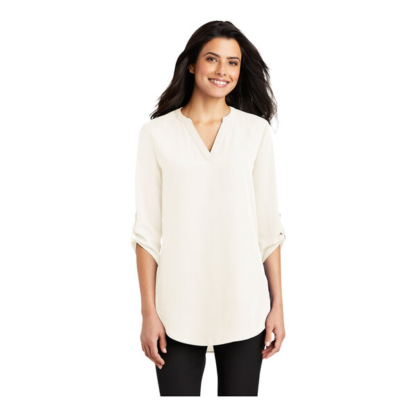 A woman wearing an ivory Port Authority chiffon short sleeve blouse with a v-neck.