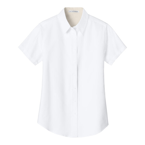 A white Port Authority short sleeve dress shirt for women on a hanger.