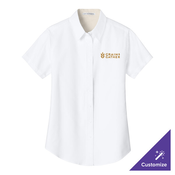 A white Port Authority short sleeve dress shirt for women with gold embroidery.