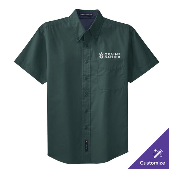 A dark green Port Authority short sleeve dress shirt with a logo on it.