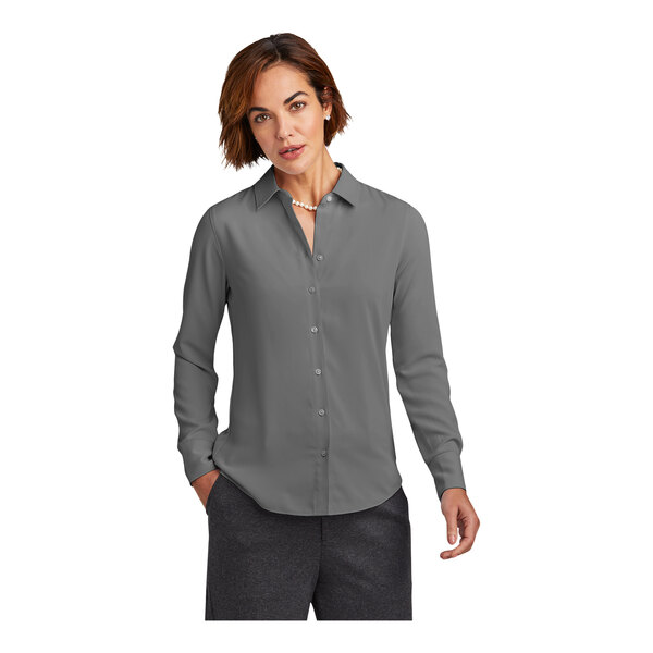 A woman in a Brooks Brothers shadow gray long sleeve full-button satin blouse.