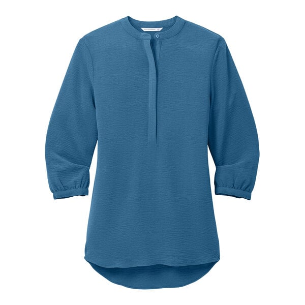 A Port Authority women's Aegean blue short sleeve blouse with a buttoned collar.