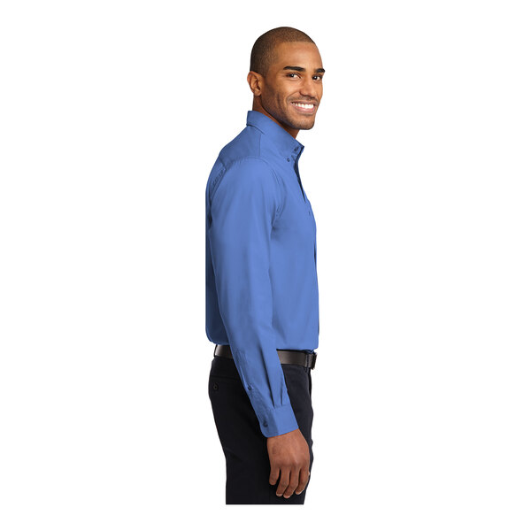 A man wearing an ultramarine blue Port Authority dress shirt.