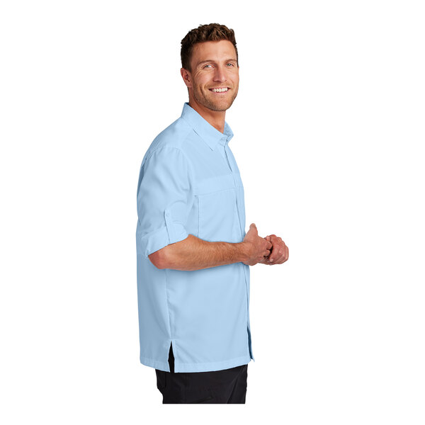 A man wearing a Port Authority light blue long sleeve shirt.