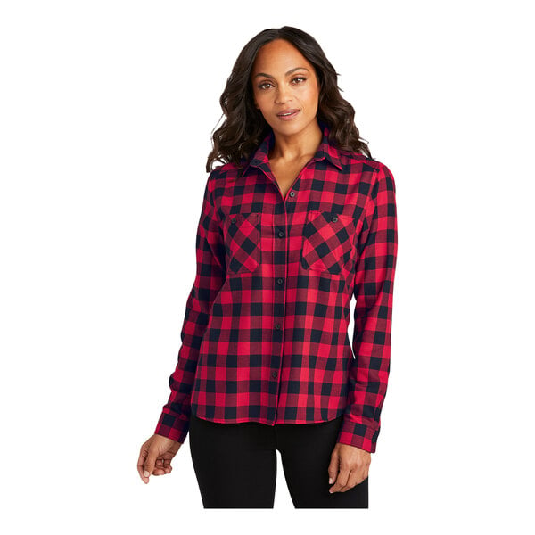 A woman wearing a red and black plaid Port Authority flannel shirt.