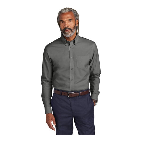 A man with grey hair and a beard wearing a deep black Brooks Brothers stretch pinpoint dress shirt.